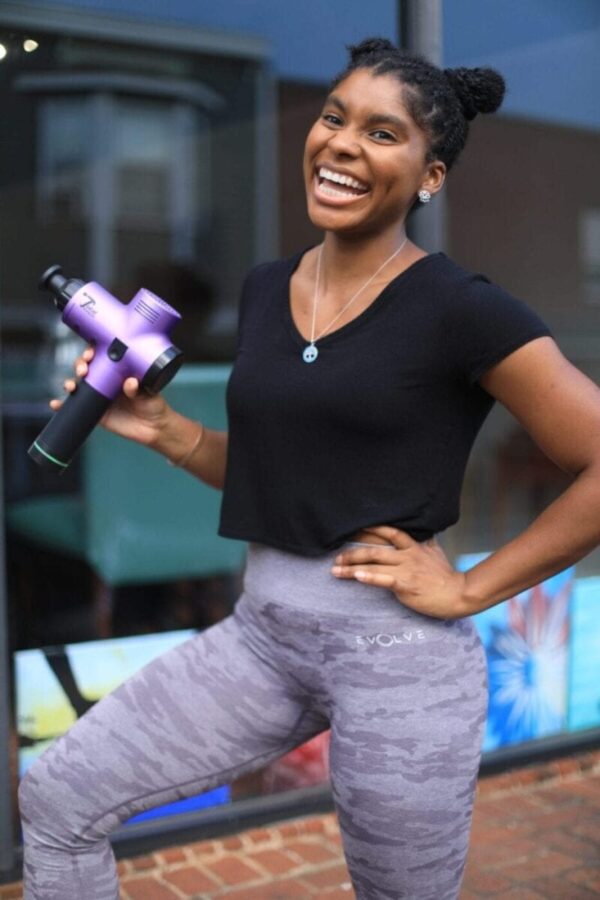 women athlete holding total massage gun