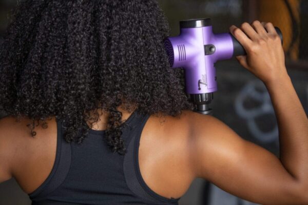 women doing massage with total massage gun